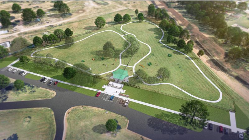 Overhead view of dog park with two separate fenced areas and agility equipment for dogs