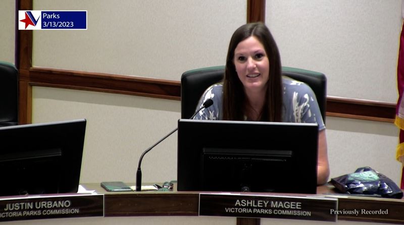 Woman seated at council dais