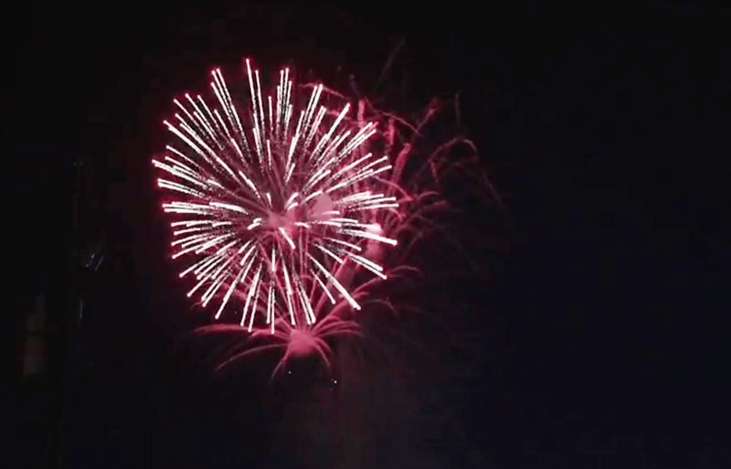 Red fireworks against dark sky