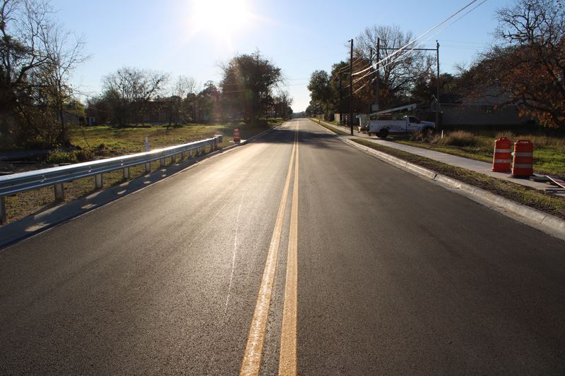 A newly paved and striped asphalt road