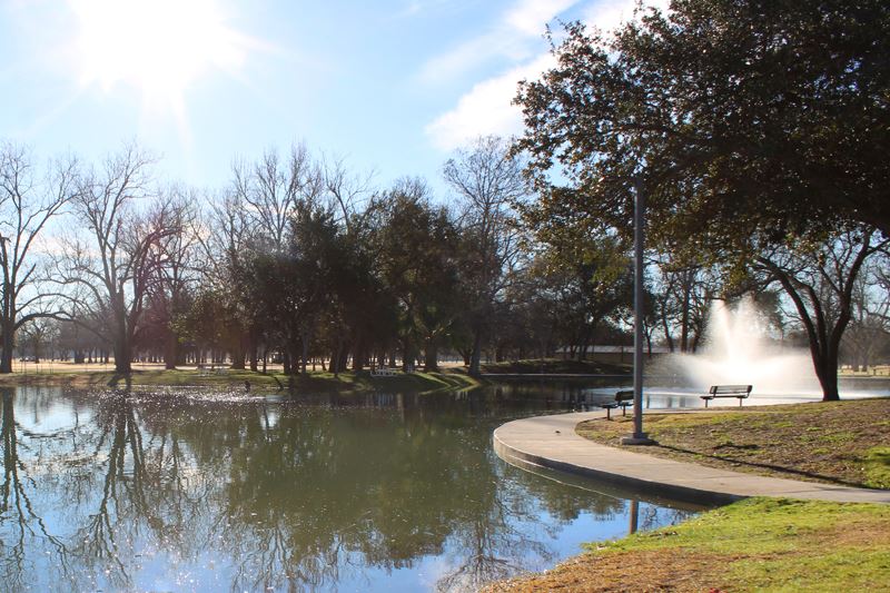 Riverside Park duck pond with a wide sidewalk, a decorative fountain and benches
