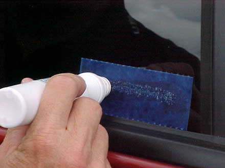 Person Using Glue to Apply a VIN Etching