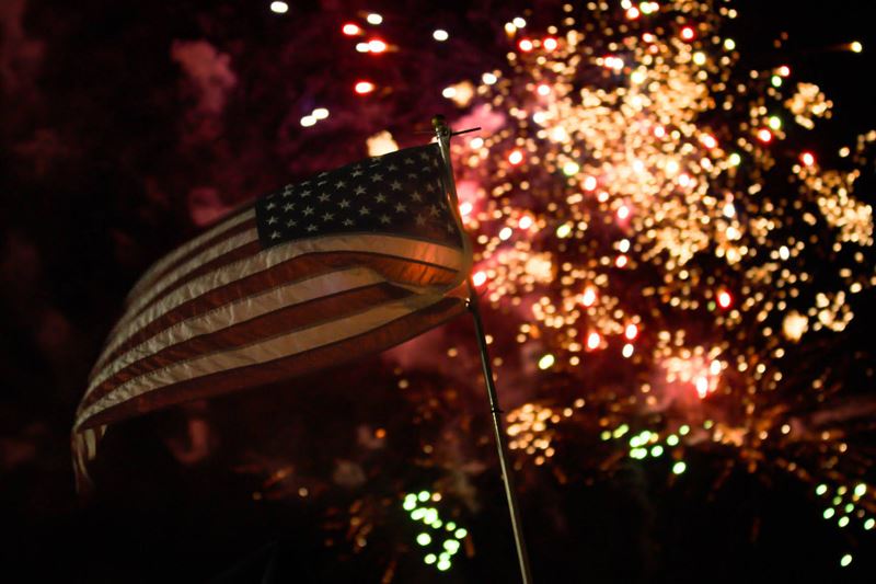 American flag with fireworks in background