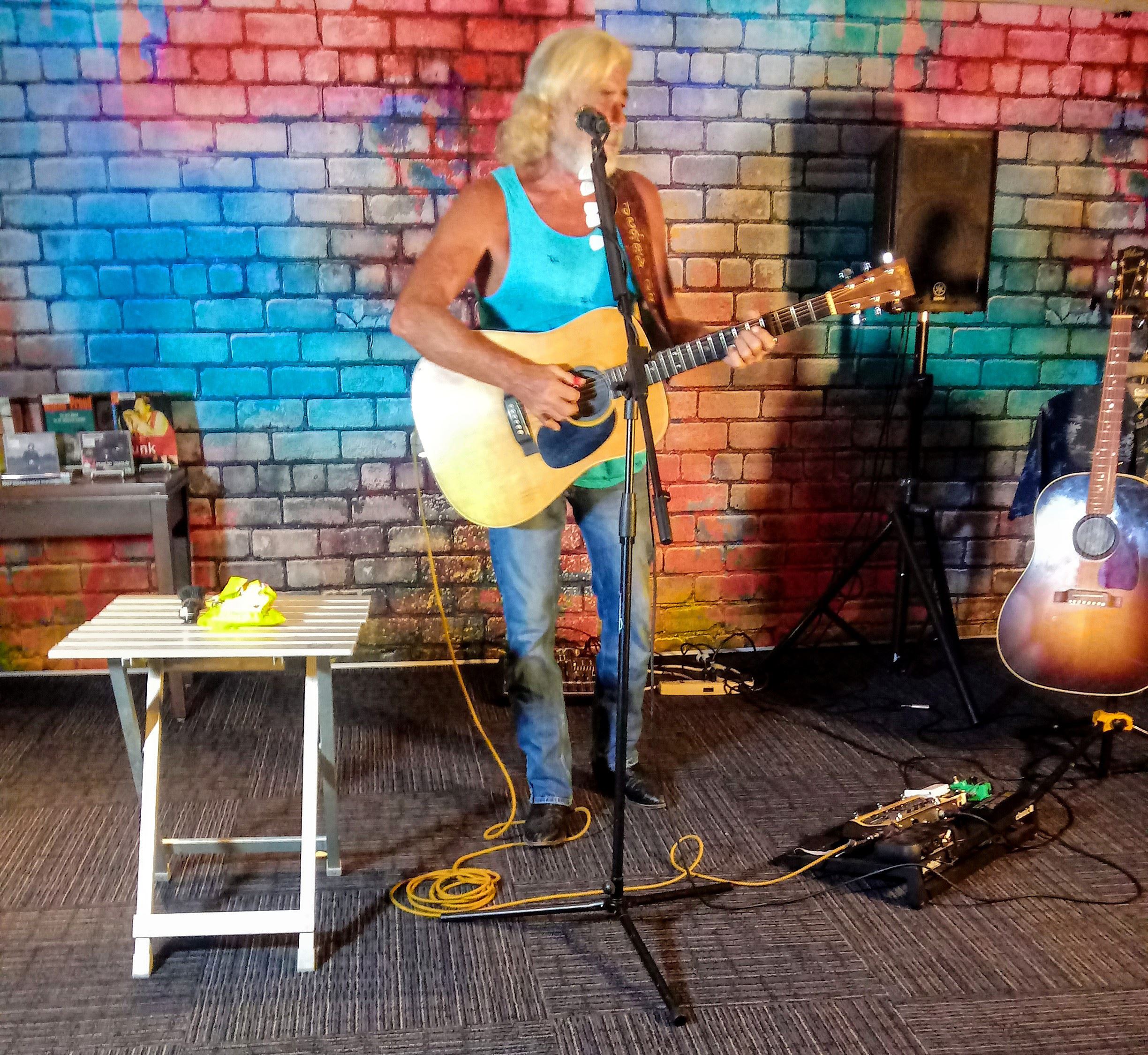 Singer/songwriter Jerry James plays guitar in library's Bronte Room