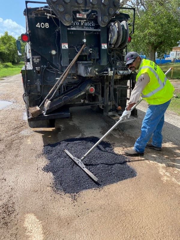 Bryant Stamps repairs a pothole using one of the City of Victoria’s patch trucks.