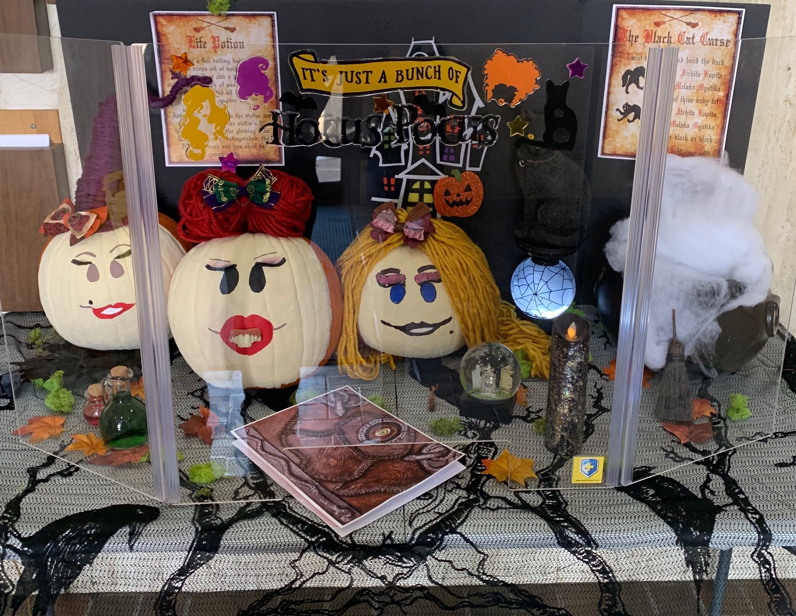 Pumpkins decorated as the witches from Hocus Pocus with crystal ball, cauldron and similar items