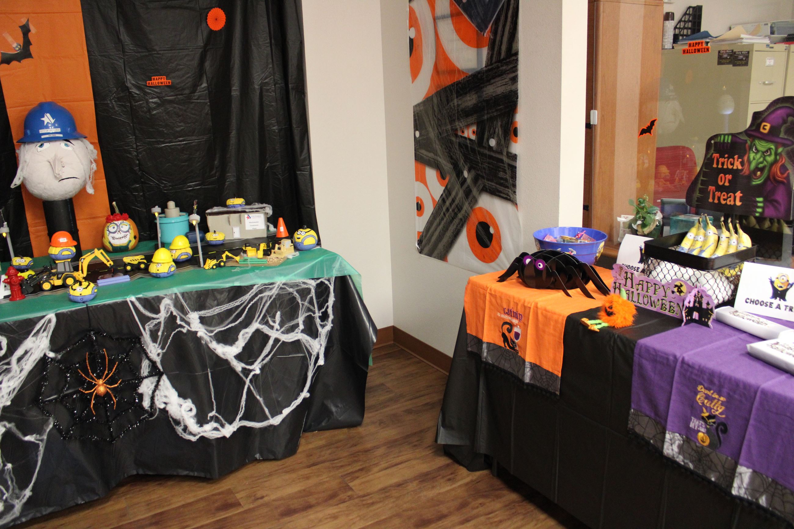 Despicable Me Minions cityscape. Nearby table has Minion-themed snacks.