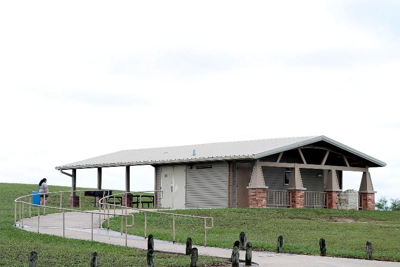An events pavilion with a winding uphill sidewalk leading to it