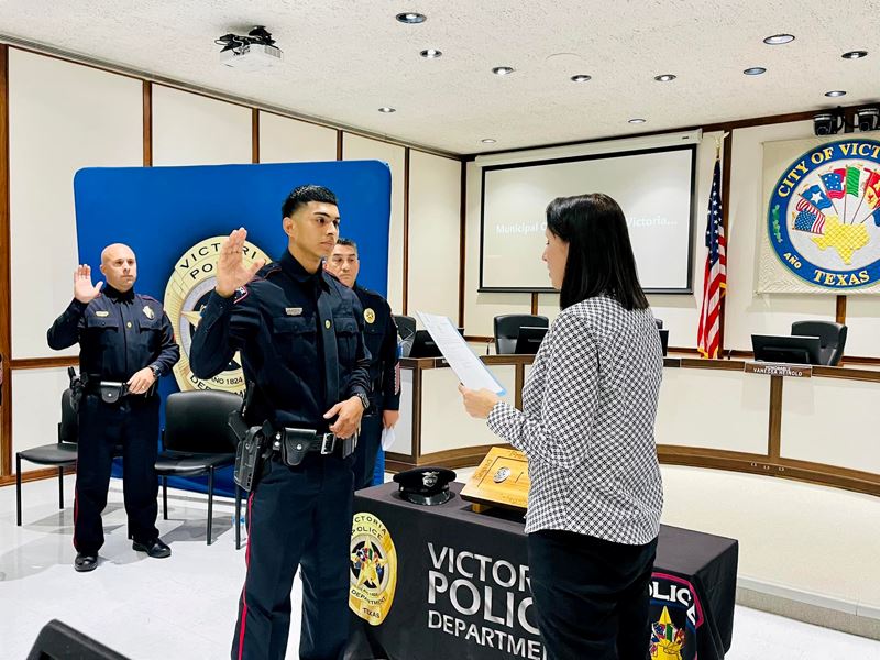 Man in police uniform is sworn in at City Council chambers