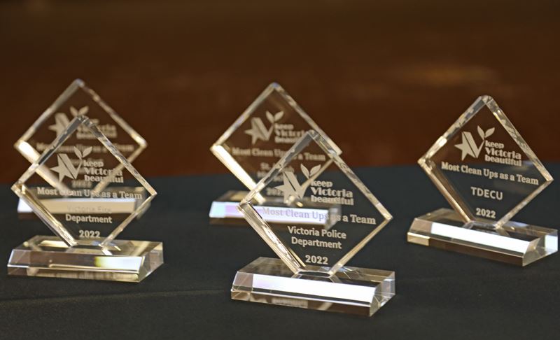 Small diamond-shaped glass trophies engraved with KVB logo and the phrase Most Cleanups as a Team