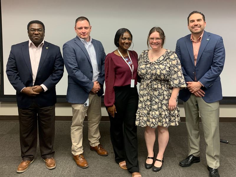Group photo in upstairs conference room at 700 Main Center