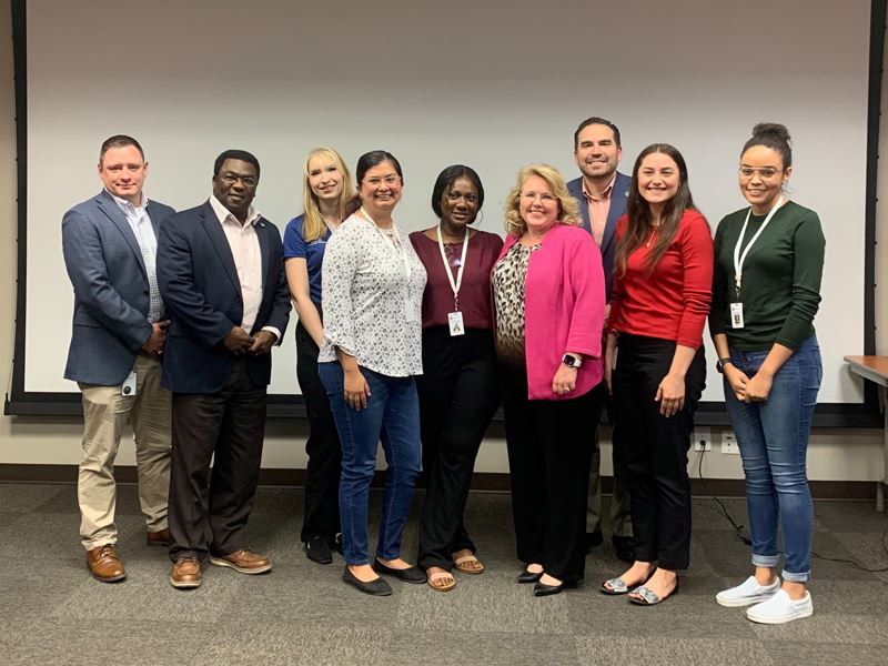 Group photo in upstairs conference room at 700 Main Center
