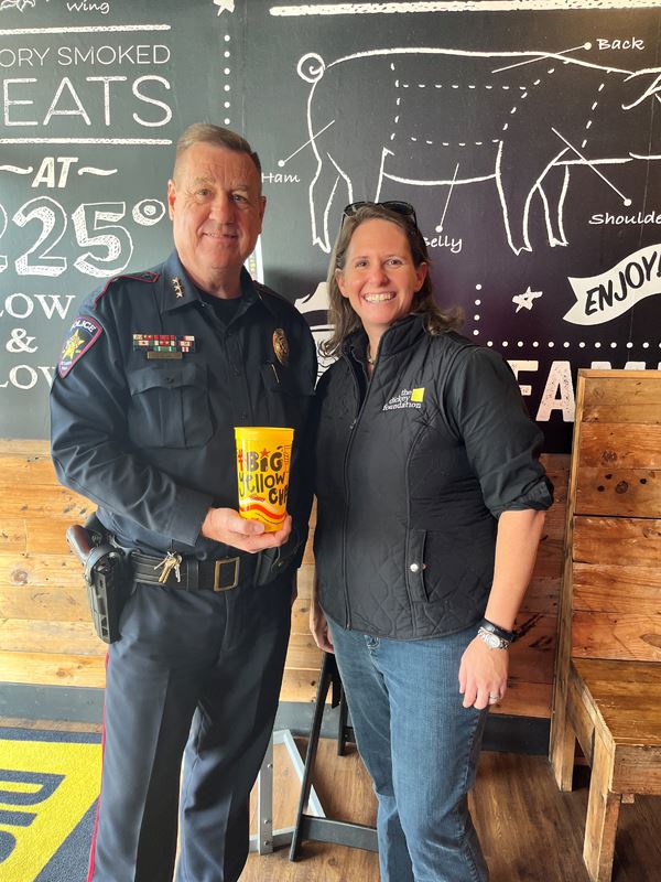 Police Chief Chuck Young and a woman in a Dickey Foundation shirt pose for a photo