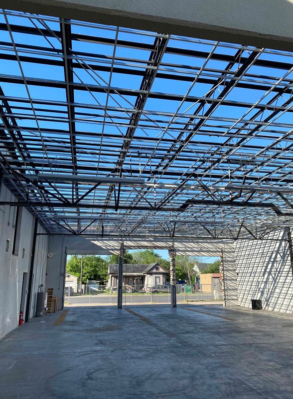 Building under construction with exposed roof framework