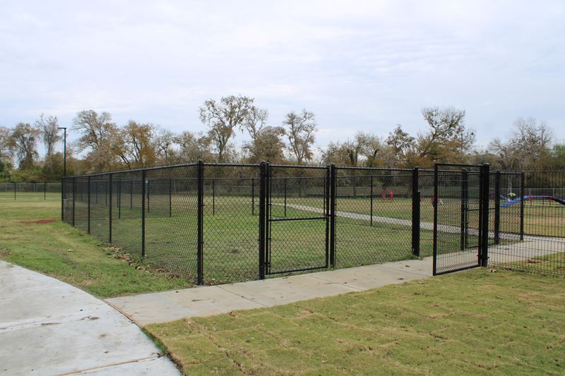 A small rectangular fenced area within the dog park
