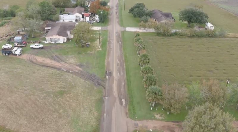 Drone footage of a street with severe damage, potholes and partial collapsing