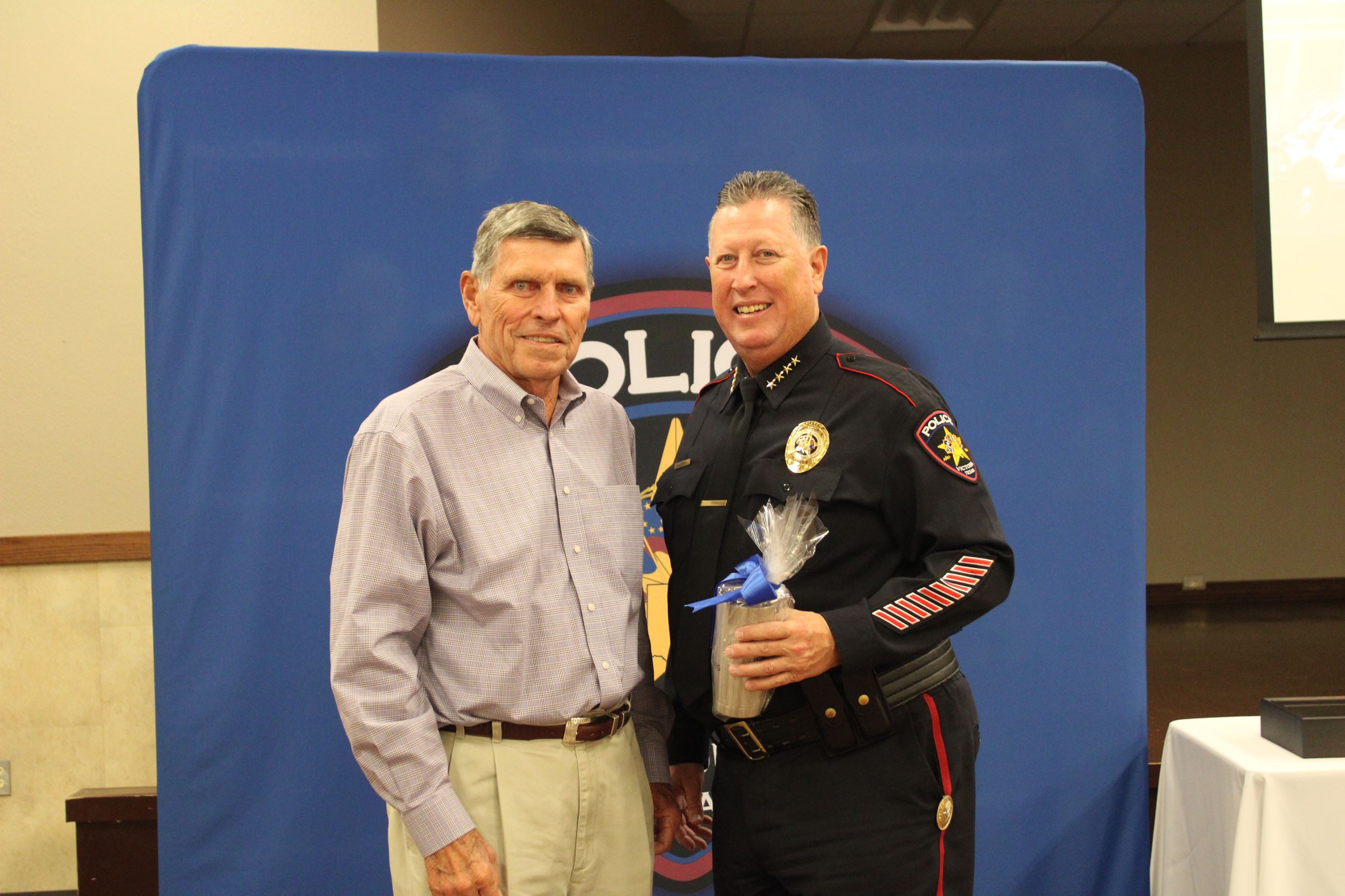 Ben Nix presents J.J. Craig with a commemorative Yeti tumbler