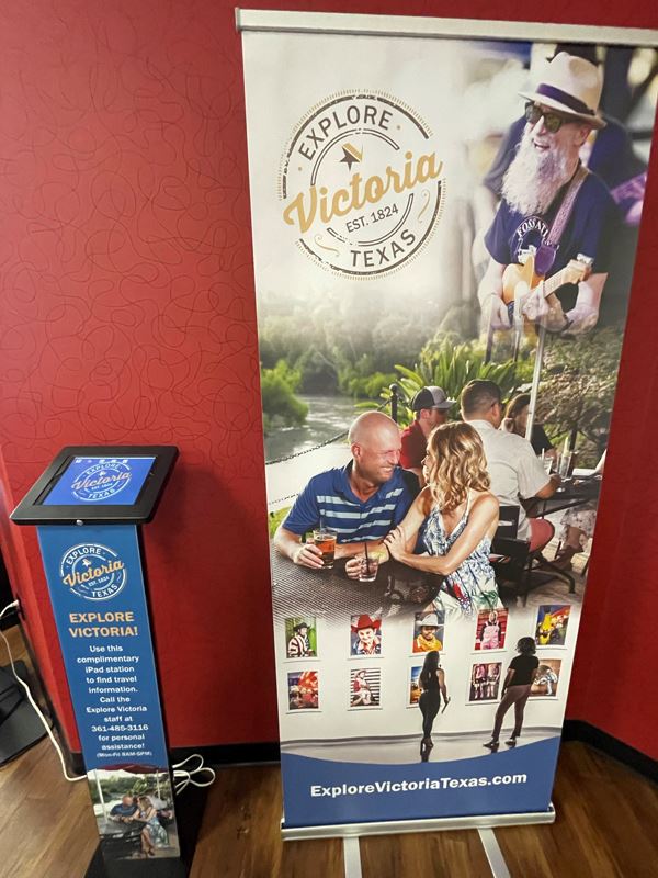 iPad station next to Explore Victoria Texas banner