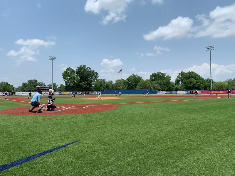 Wide shot of people playing baseball