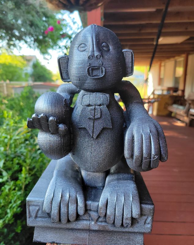 A 3D printed gray plastic statue of a monkey from the show Legends of the Hidden Temple